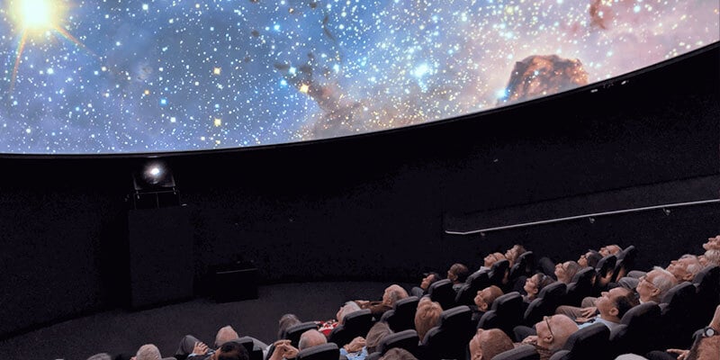 Visitors watching a presentation inside the ICR planetarium